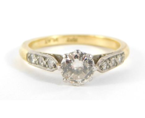 A diamond set dress ring, with single round brilliant cut diamond in eight claw setting, approx 0.22ct overall, with three ti