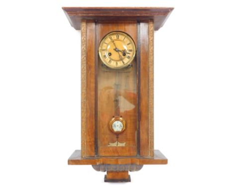 A late 19thC walnut cased wall clock, the circular brass dial with chapter ring bearing Roman numerals, eight day movement, t