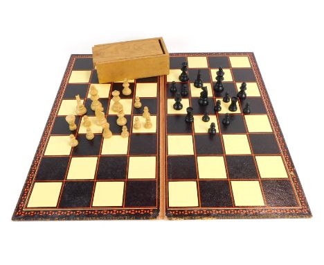 A Staunton type wooden chess set, in wooden case with chess and draughts board, bearing label for K&amp;C Ltd. (2) 