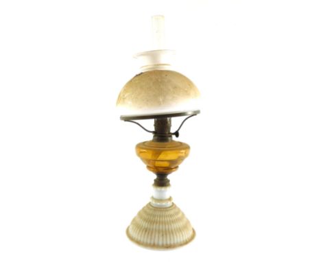 A Victorian opalescent glass oil lamp, with amber glass reservoir, glass chimney, and white glass shade, 52cm high. 