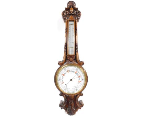 A Victorian oak aneroid wheel barometer, with thermometer, the case carved with leaves and c scrolls, 83cm high. 