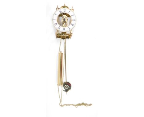 A Hermle skeleton wall clock, with white chapter ring with Roman numerals and an open movements, with drop weight chains and 