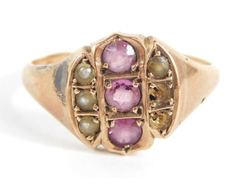 A Victorian dress ring, the central circular panel with three amethysts, and outer rows of three seed pearls (2 missing), on 