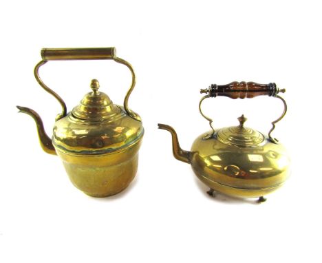 Two brass kettles, comprising a 19thC copper kettle, 31cm high, and a later teapot, with brown glass handle, 22cm high. (2) 