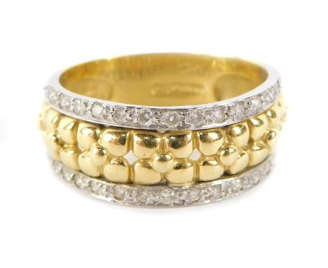 An 18ct gold diamond set half hoop dress ring, the central panel with yellow gold flowers, with outer white gold border set w