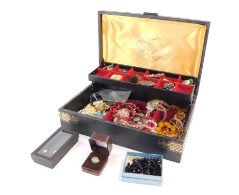 A black and gilt decorated jewellery box and contents, comprising brooches, imitation jet necklace, wristwatch, faux pearl ne