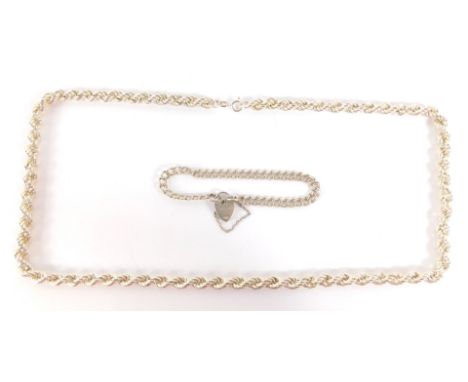 Two silver chains, comprising a modern rope twist neck chain, stamped Italy 925, 64cm long, together with a silver two row cu