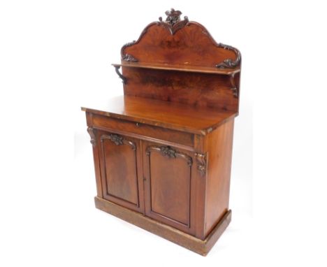 A Victorian mahogany chiffonier, the single shelf back with floral and foliate carving, above a cushioned drawer, over two pa