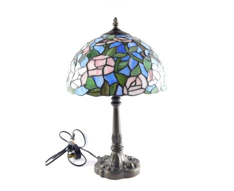 A Tiffany style table lamp, the domed shade with flowers and humming birds, in blue, pink and green glass, on a taped base, 5