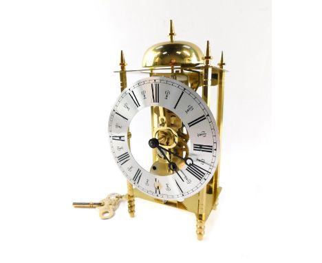 A German brass lantern type mantel clock, with silver coloured chapter ring bearing Roman numerals, and openwork movement, wi