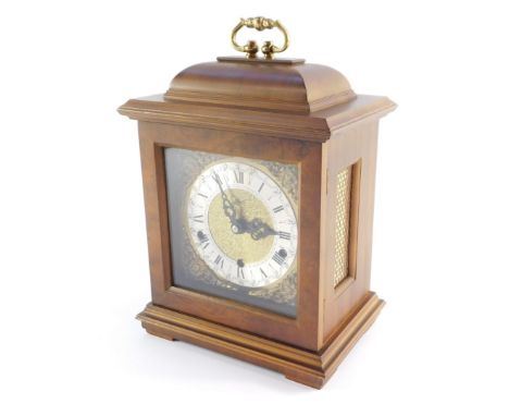 A Schatz walnut cased mantel clock, with square dial having brass spandrels cast as Amorini, chapter ring bearing Roman numer