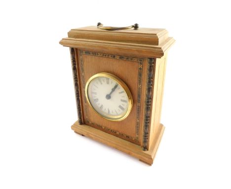 A late 20thC walnut cased mantel clock, circular dial bearing Roman numerals, clockwork movement with bell strike, the rectan
