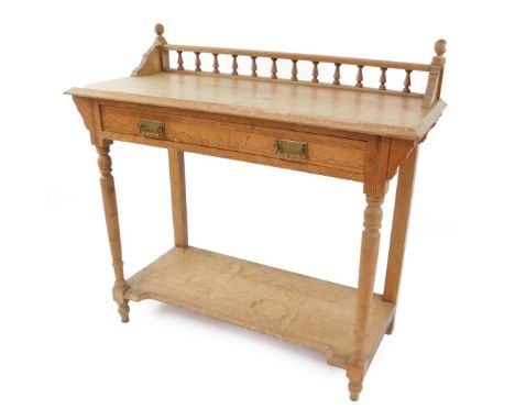 A Victorian oak washstand, with galleried back, above a single frieze drawer, raised on turned legs, united by an under shelf