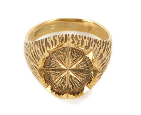 A 9ct gold signet ring, the oval central panel with bark effect detailing on rushed design shoulders, maker HS Limited, Birmi