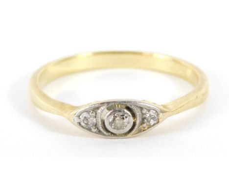 An Art Deco style diamond set ring, the shaped panel set with three tiny diamonds, in a white gold setting, on a raised baske