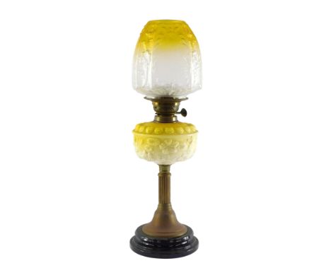 A Victorian white and yellow opaline glass and brass oil lamp, with a fluted column and floral moulded glass reservoir, no ch