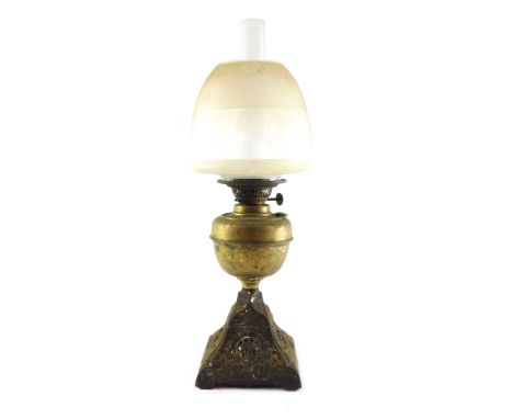 A Duplex brass and cast oil lamp, with an Art Nouveau floral base, brass reservoir, glass chimney, and clear and etched glass