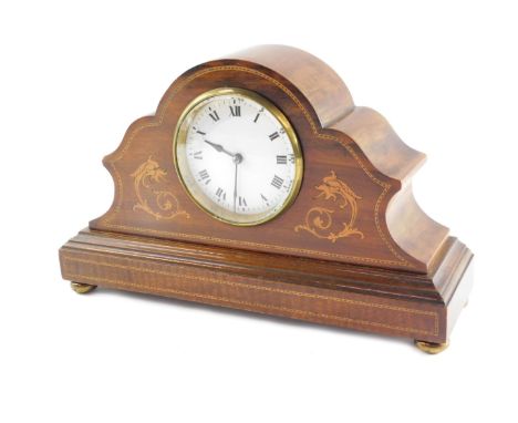 An Edwardian mahogany and inlaid mantel clock, circular white enamel dial bearing Roman numerals, French clockwork movement, 