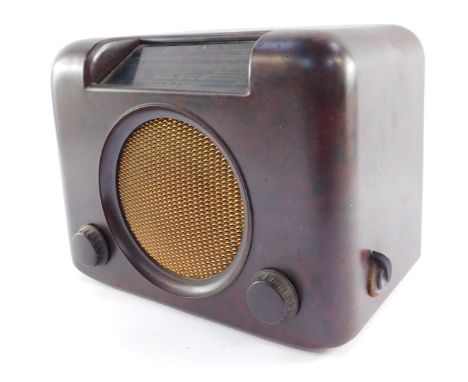 A Bush vintage radio, in a mottled brown Bakelite case, with gold finish grill, type DAC 90A, 25cm high, 29cm wide, 19cm deep
