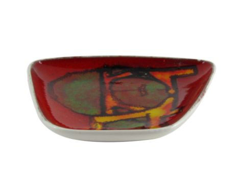 A Poole Delphis pottery pin dish, of abstract shaped form, on a red ground with orange and green detailing, and Poole stamp t