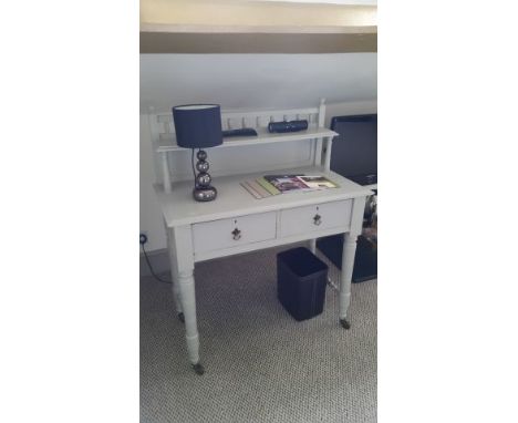 Grey painted desk with galleried upper shelf, brass handles, castors. Two short drawers. 85.5 cm wide, 45 cm deep, 76 cm high