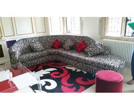 Large zebra stripe sofa with curved back (base is in two almost equal-sized sections, backrest is a third section, top long c