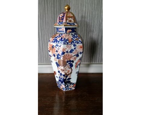 Pair of Chinese ceramic lidded jars, white ground with blue and amber pattern, 44 c high, from the Conference Room. They can 