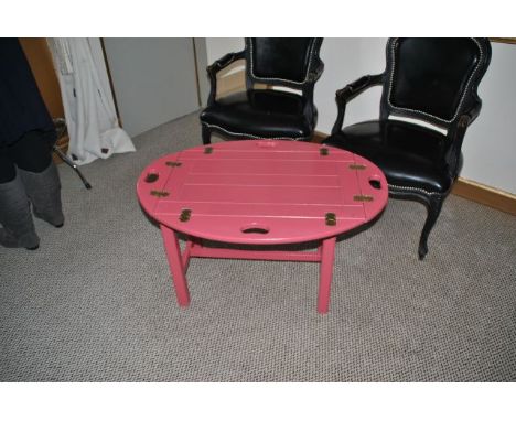 Oval shaped butlers tray table painted pink, brass fittings. At widest points with flaps down 86cm wide, 60 cm high, 62 cm de