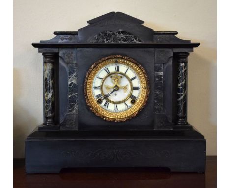 Victorian black slate cased architectural style mantel clock, the off-white dial with Roman numerals and visible escapement  