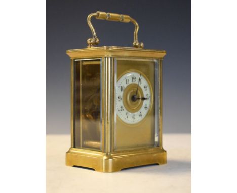 French brass cased carriage clock, the dial with off-white chapter ring set within a brass mask   Condition: 