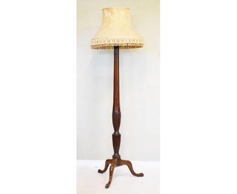 Walnut and beech standard lamp having a carved column and standing on a tripod base   Condition: 