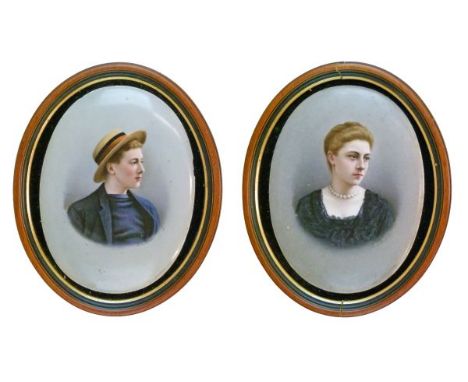 Pair of late 19th Century German porcelain oval portrait plaques, possibly Berlin, decorated with a young man wearing a straw