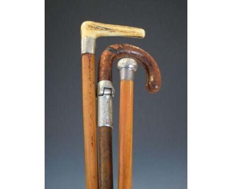 Two silver mounted walking sticks and a shooting stick   Condition: 