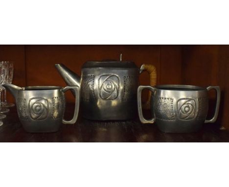 Roundhead pewter three piece tea service having Arts & Crafts design embossed and hammered decoration   Condition: 