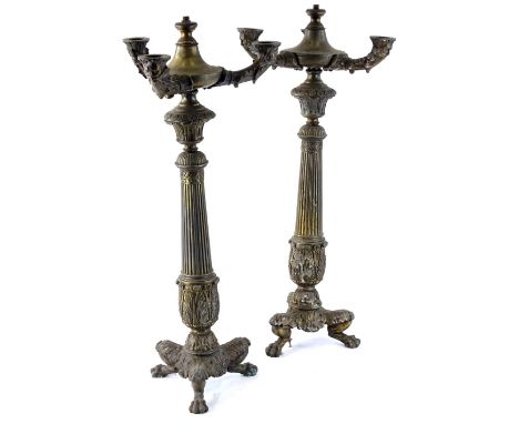 A pair of French Empire style lamp bases, each with a reeded column and three leaf cast legs and paw feet, 59cm H.