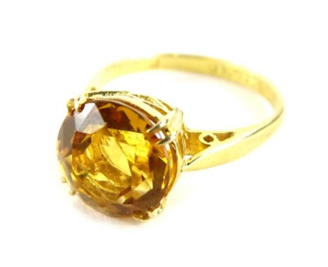 A citrine dress ring, with single round faceted citrine measuring 9.9mm x 9.9mm x 6.6mm, in four double claw setting, in rais