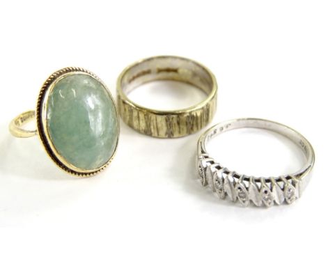 Three dress rings, comprising a 9ct gold and jade dress ring, an 18ct white gold half hoop eternity ring set with diamonds an