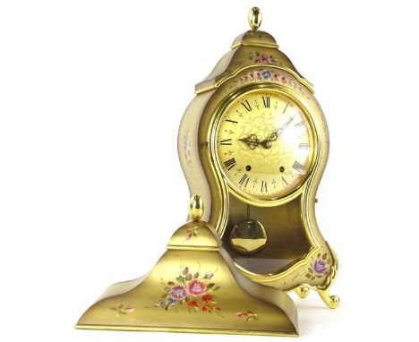 A modern Elusea mantel clock, with a shaped case with glazed front revealing visible pendulum with similar decorative floral 