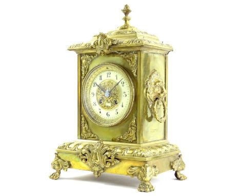 A 20thC rococo style gilt metal mantel clock, the elaborate stepped case with floral finial raised above lions or side lions 