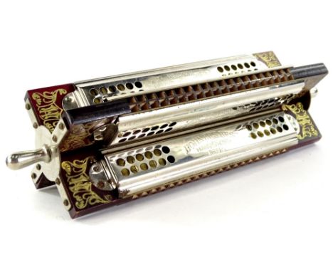 A Hohner pedal wheel four sided harmonica, stamped Made in Germany, with chrome plated mounts, boxed.