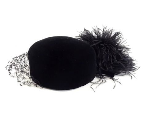 A vintage Christian Dior black hat, with front veil and feathered type tassel, with Diorling label, in outer box.