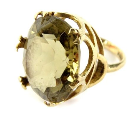 A 9ct gold dress ring, with oval cut citrine, in six double claw setting, in a raised basket, ring size K, 6.7g all in. 