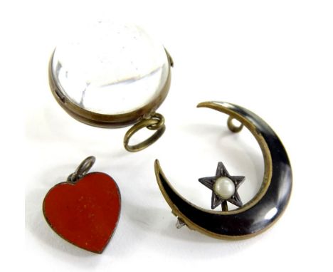 Three items of jewellery, comprising a rock crystal pendant with gilt metal frame, an orange agate heart pendant and a black 