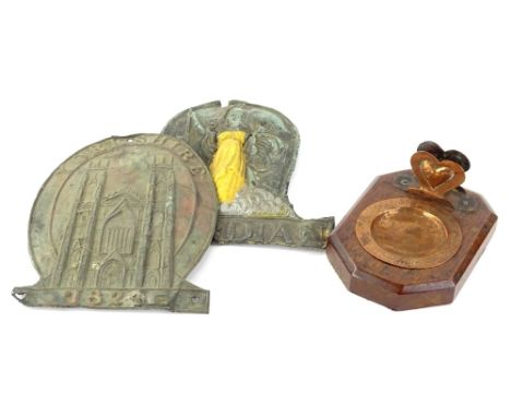 An Arts and Crafts oak and hammered copper smokers stand, decorated with a stylised harp on a rectangular canted base, and tw