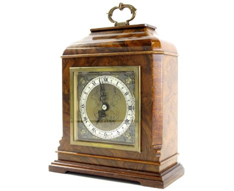 A mid 20thC walnut cased Elliott mantel clock, in caddy case with twined floral handle, fancy dial with raised cherub spandre