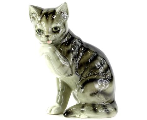 A Goebel Hummel figure, of a standing cat licking its front paw, printed marks beneath, 26cm H.