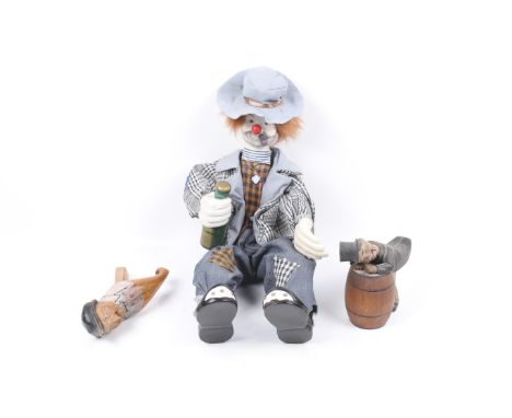 Three vintage novelty figures. Comprising a wooden model of a man hunched over a barrel, a carved and painted man with a move