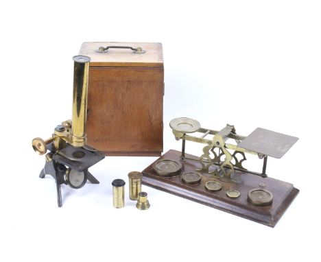A vintage cased brass microscope and set of postage scales. The scales stamped S. Mordan & Co., London, with five weights. Th