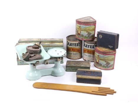A collection of vintage John Player advertising tins and a set of kitchen scales. The tins of various sizes and styles, the b