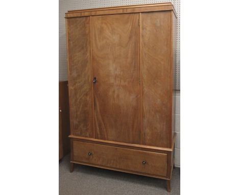 An early 20th century light wood wardrobe. The door opening to reveal a clothes rail and three hooks, over a single long draw